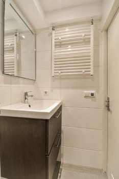 a bathroom with a sink, mirror and toilet paper dispensed on the wall next to the vanity