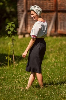 young woman in ukrainian national costume outdoors