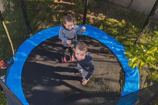 children jumping on a trampoline top view