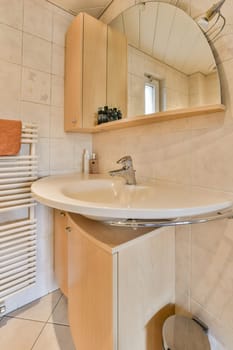 a bathroom with a mirror on the wall and a towel rack in the corner next to the sink is white