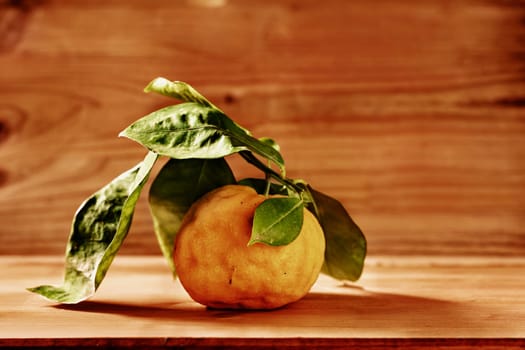 Orange on wooden table , fresh fruit with green leaves , healthy eating