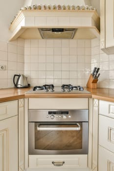 a small kitchen with an oven and toaster on the wall above the range hood in front of the stove