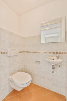 a bathroom with tile flooring and white tiles on the walls, there is a mirror above the toilet bowl