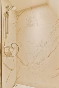 a bathroom with marble walls and white tiles on the wall, there is a toilet in the shower stall next to the bathtub