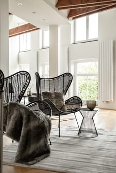 Two black designer chairs in a cozy chilling space of modern luxury house