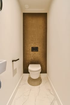 a modern bathroom with marble flooring and white walls, along with a toilet in the wall is painted gold