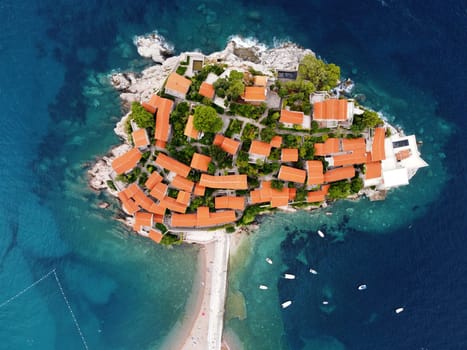 Aerophotography. Aerial view of Sveti Stefan island in a beautiful summer day, Montenegro from flying drone. Panoramic above view of Saint Stephen luxury resort. Tourism and leisure concept