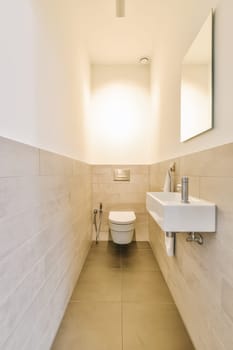 a bathroom with a toilet, sink and mirror on the wall next to each other items in the photo is blurry