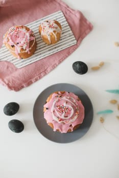 Happy Easter cake with sprinkles on glaze. Cake on light rustic board. Homemade bakery