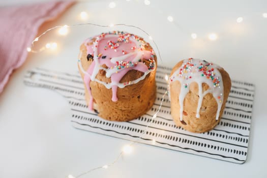 Happy Easter cake with sprinkles on glaze. Cake on light rustic board. Homemade bakery