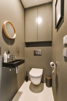 a bathroom with a toilet, sink and mirror on the wall next to it is a light that is shining in the corner