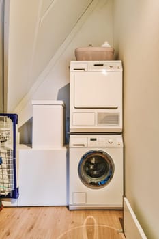 a laundry room with a washer and dryer next to the washing machine that is in front of it