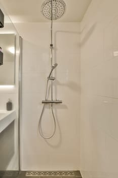 a shower in a bathroom with white tiles on the walls and floor, it appears to be used as a shower head