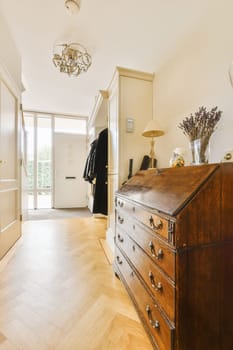 a bedroom with an old chest in the middle of the room, and a large mirror hanging on the wall