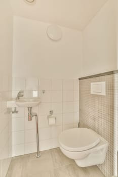 a white toilet in a bathroom with tile on the walls and flooring around the toilet bowl, there is a mirror above it