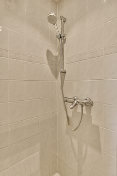 a shower with white tiles on the walls and floor in a tiled bathroom area, it appears to be used as a walk - in shower