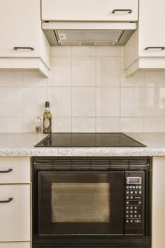 a small kitchen with a microwave and oven on the counter top in front of the stove, which has been used for cooking