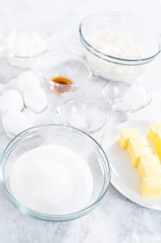 Ingredients in glass mixing bowls to bake July 4th bundt cake with chocolate stars.