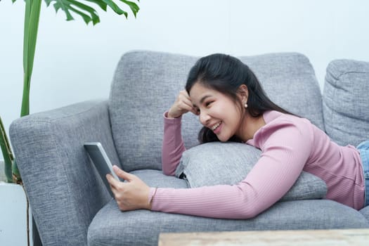 Portrait of a beautiful Asian teenage girl using a tablet computer.