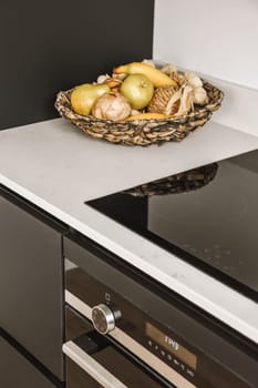 some food in a bowl on the stove top and an oven with two burners next to each other items