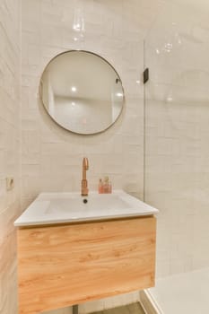 a bathroom with white tiles and wooden vanity in the shower stall, which is also used as a bath room