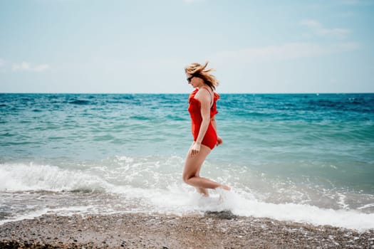 Pretty young blonde woman walking on the beach in summer, having fun, walks carefree on the seaside . Portrait beautiful young woman relax smile around beach sea ocean in holiday vacation travel trip.