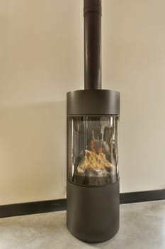 a wood burning stove in the corner of a room with white walls and black trim on the wall behind it