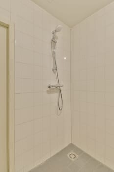 a shower room with white tiles on the walls and tile around the bathtub, which has been used for several years