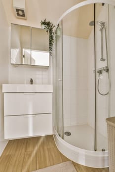 a bathroom with wood flooring and white tiles on the walls, along with a large walk - in shower