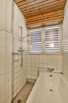 a bathroom with a bathtub and shower stall in the corner, all made out of white ceramic tiles on the floor