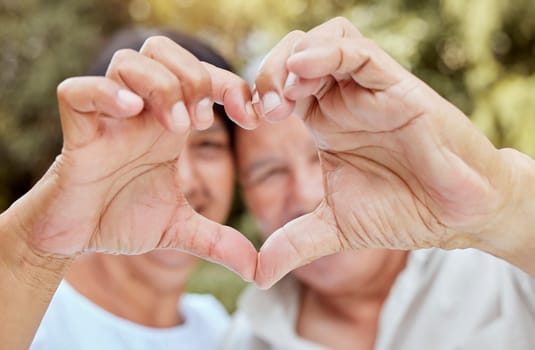 Heart hands, love and senior couple, happiness and kindness, trust and support in garden park. Closeup marriage, finger shape and celebrate care relationship, anniversary date and relax retirement.