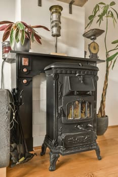 a wood burning stove in the corner of a living room with a plant and an old clock hanging on the wall