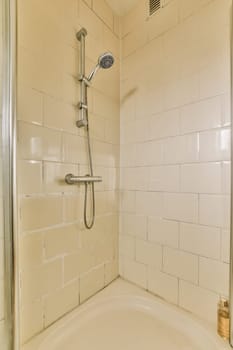 a bathroom with a bathtub, shower head and hand held in the corner of the tub is made out of glass