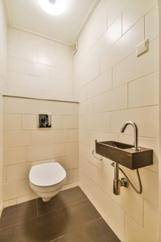 a white toilet in a small room with tile flooring and walls that have been painted to look like wallpapers