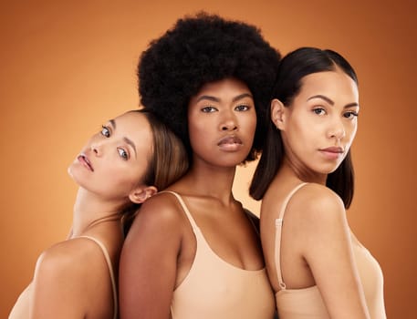 Diversity, skincare and beauty with model woman friends in studio on a brown background for inclusion. Health, luxury and portrait the a female group standing together for wellness or healthy skin.