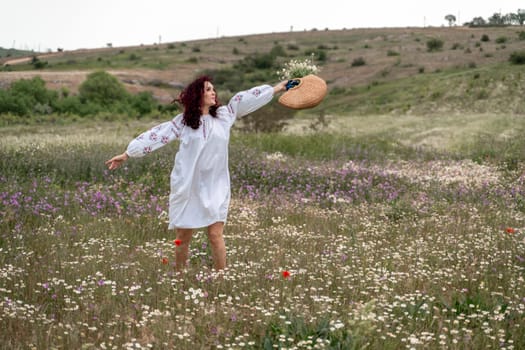 Chamomile woman. Happy curly woman in a chamomile field, dressed in a white dress