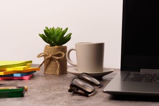 Office desk with laptop, and other work tools with coffee cup. with copy space for entering text.