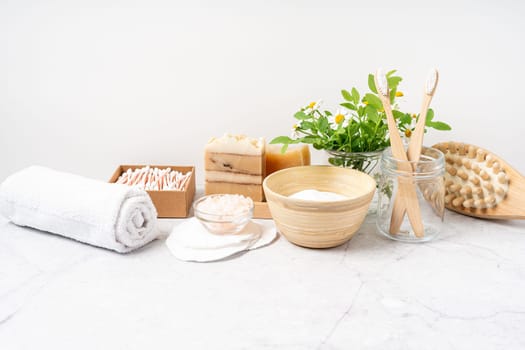 Natural bathroom and home spa tools. Zero waste sustainable lifestyle concept. Bamboo toothbrush, natural soap bar, cotton pads and swabs, homemade DIY beauty products on white background.