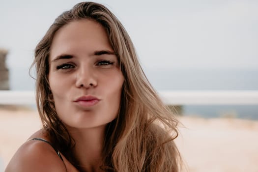 Happy woman portrait in cafe. Boho chic fashion style. Outdoor photo of young happy woman with long hair, sunny weather outdoors sitting in modern cafe