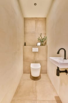 a bathroom with a toilet, sink and plant on the wall next to the bathtub in the shower room