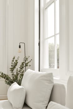 Snow-white pillows and a sofa by the window fit perfectly into the interior