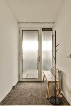 an empty room with two doors and a bench in the middle one door is open, while the others are closed