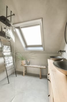 a bathroom with a skylight above it and a sink in the corner, next to a mirror on the wall