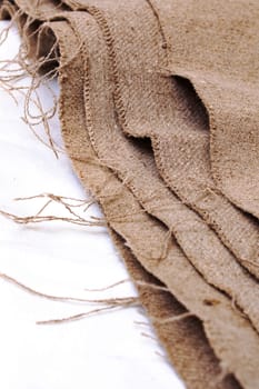 Gray burlap cloth close up on white background