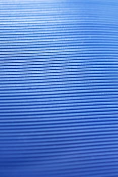 Abstract background of blue stripes on plastic close up
