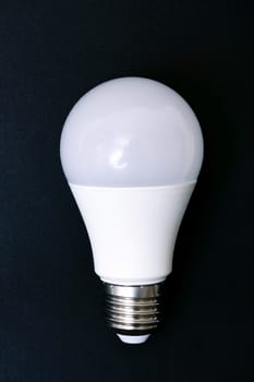 White light bulb and the word idea on a gray background, copy space