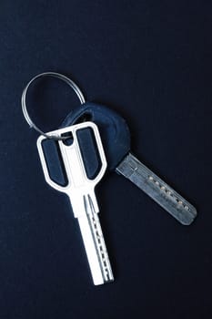 Door keys on a black background close up, copy space