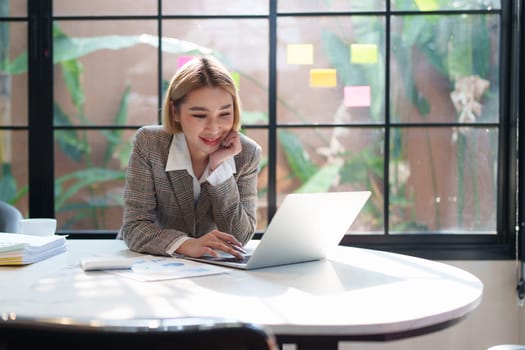 Portrait of Business woman analytic finance statistics and planning strategy by laptop. tax, report, accounting concept.