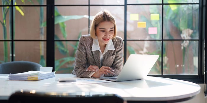 Portrait of Business woman analytic finance statistics and planning strategy by laptop. tax, report, accounting concept.