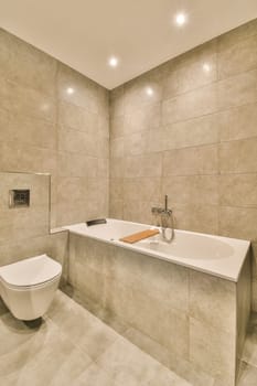 a bathroom with a toilet, sink and mirror in the wall behind it is a tile pattern on the floor